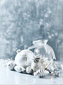 Arrangement of silver and white Christmas decorations