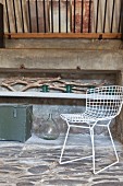 Stone floor, driftwood and white wire chair in rustic ambiance