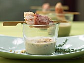 Garlic soup in a glass with red mullet fillet skewers