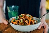 Wholegrain spaghetti with carrot strips and sesame seeds