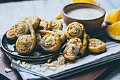 Palmier pastries with almond flakes and orange cream