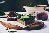 Slices of bread topped with beetroot and cucumber