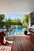 Filigree metal table on the covered terrace by the pool