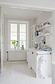 Kitchen counter next to window in white kitchen