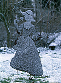 Iron sculpture 'Lady with flower' in hoarfrost