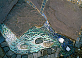 Stylised waterfall as mosaic in pavement
