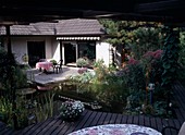 Garden with paved seating area, pond