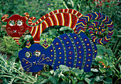 Sowing cats made of painted tin