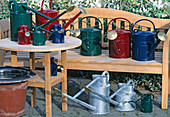 Watering cans in various colours and shapes