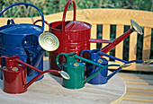 Watering cans of metal in colours