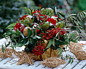 Winter bouquet of roses, proteas, berries and cones