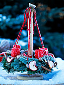Advent wreath hanging on a table stand with hoarfrost