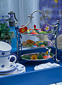 Silver-plated etagere with colourful Easter eggs and primrose blossoms