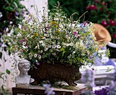 Iron jardiniere with meadow flowers