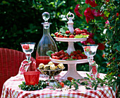 Summer table with porcelain storage with strawberries, strawberry liqueur