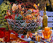 Metal basket: Cucurbita (pumpkins), Rosa (rosehips), Acer (maple foliage), Physalis (lantern flowers)