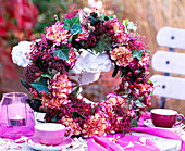 Autumn wreath with carnation dianthus, erica and berry ornaments