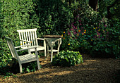 Seat on gravel terrace in the garden