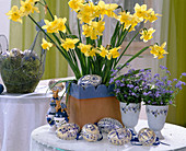 Easter decoration with narcissus and blue-white Easter eggs