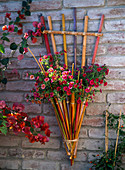 Wall basket made of differently coloured bamboo sticks