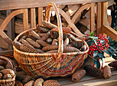 Wicker basket with handle filled with cones of Picea abies (spruce)