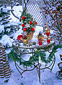 Decorated metal table at Christmas with Ilex (Holly)