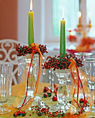 Pink (rose hips) as candle rings, glass candlesticks, green candles