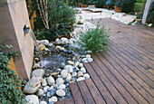 ROOF Garden with BAMBOO FENCING, White Boulders, Red CEDAR DECKING AND Water Feature: DESIGN by ALISON WEAR ASSOCIATES