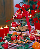 Brown metal agar with red bow topped with Malus (apples)