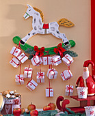 Advent calendar of white parcels on rocking horse