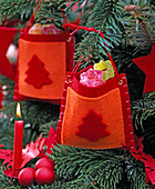 Red-orange felt bag with tree motif, filled with sweets