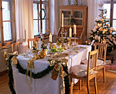 Christmas room, table laid in white and gold