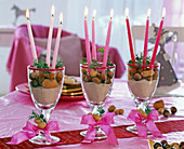 Wine glasses as a candlestick with sand and nuts