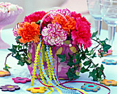 Arrangement of Dianthus (carnation) in bag, Hedera (ivy)