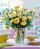 Ranunculus (ranunculus) light yellow bouquet, in glass vase