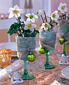 Christmas roses in wine glasses