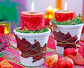 Candle in white pot with oak leaf