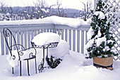 Snowy balcony, Picea (spruce), chair and table