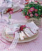 Bellis (daisy) in basket, as bouquet on white napkin