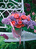 Bouquet of Syringa (lilac) and Rosa (roses) in pink vase, decorated