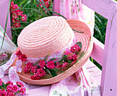 Hat decorated with blossoms of Rosa (roses)