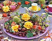 Autumn decoration with roses, berries and fruits