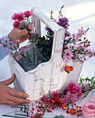 Bouquet of asters in a wooden basket (2/3)