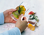 Glasses wrapped with autumn leaves as lanterns (2/3)