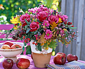 Autumn bouquet with roses and chrysanthemums