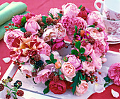 Wreath in the shape of a heart made of pink rose (roses, rose hips), Rubus (blackberries)
