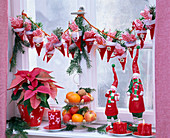 Advent calendar made of felt bags on the window, decorated with Pseudotsuga