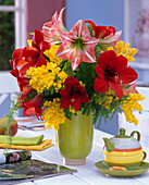 Yellow-red winter bouquet with Hippeastrum, Acacia