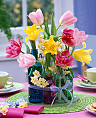 Arrangement of Tulipa, Narcissus in small glass bottles