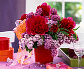 Bouquet of Paeonia (peonies) and Syringa (lilacs) with bow